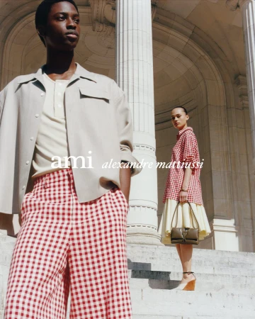 Models posing on grand stone steps by classical columns for the Ami Spring 2025 ad campaign in Paris.
