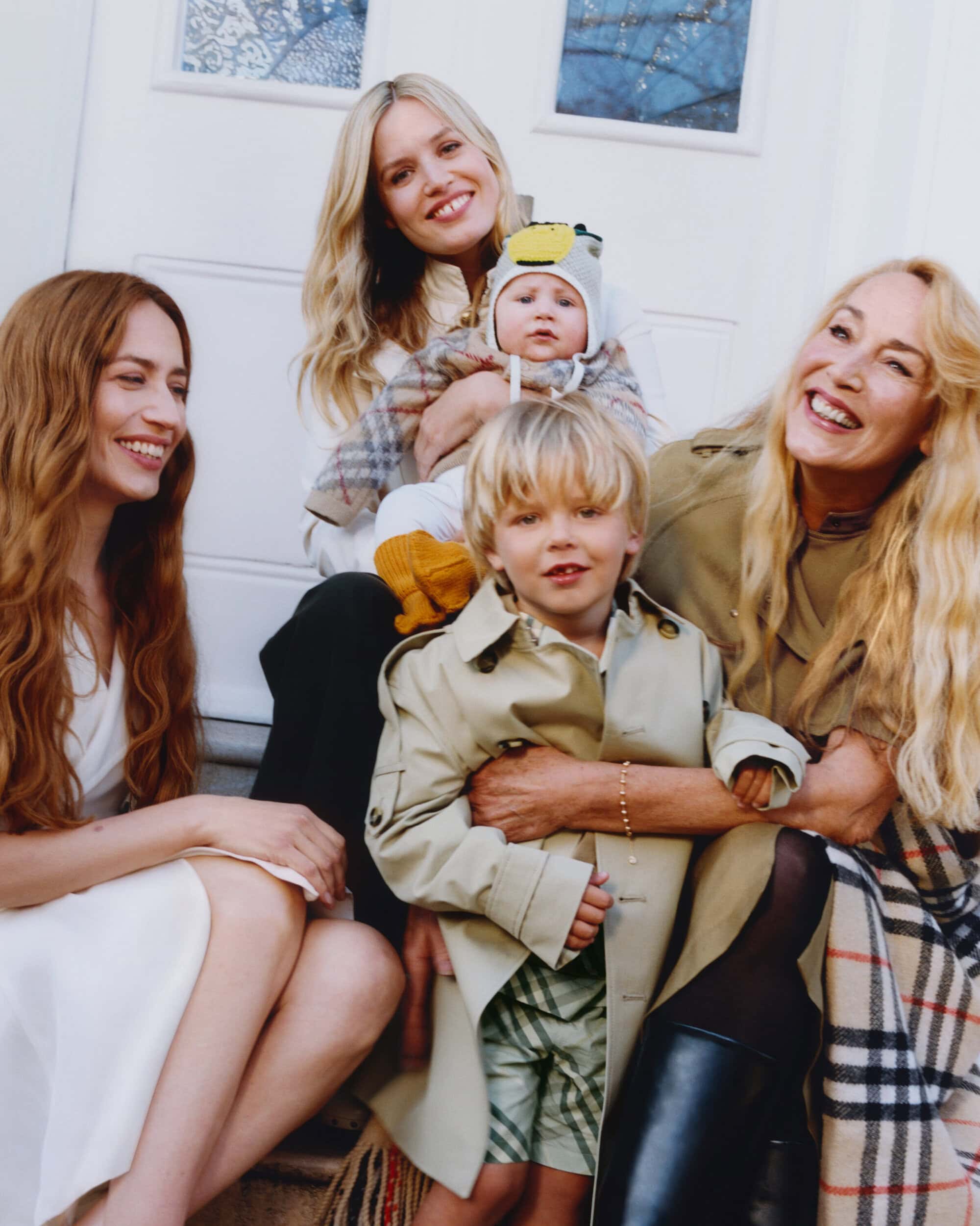Jerry Hall, Georgia May Jagger, and Elizabeth Jagger posing together on steps for Burberry