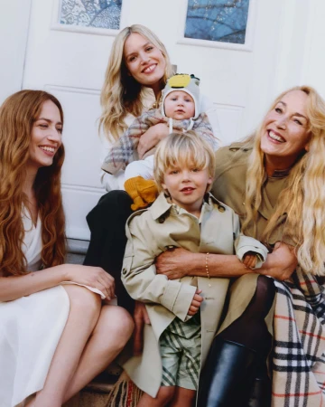 Jerry Hall, Georgia May Jagger, and Elizabeth Jagger posing together on steps for Burberry