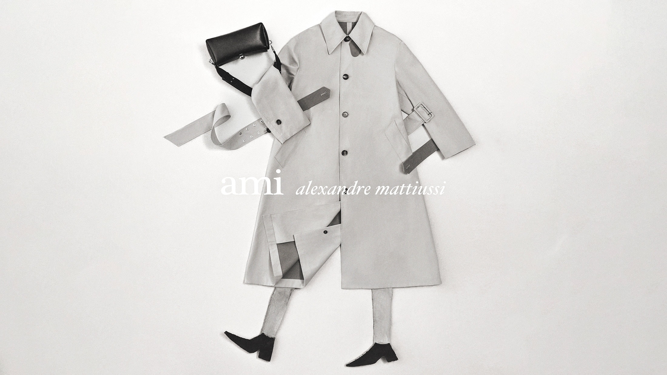 Flat lay composition of an Ami trench coat, black handbag, and boots against a plain white background