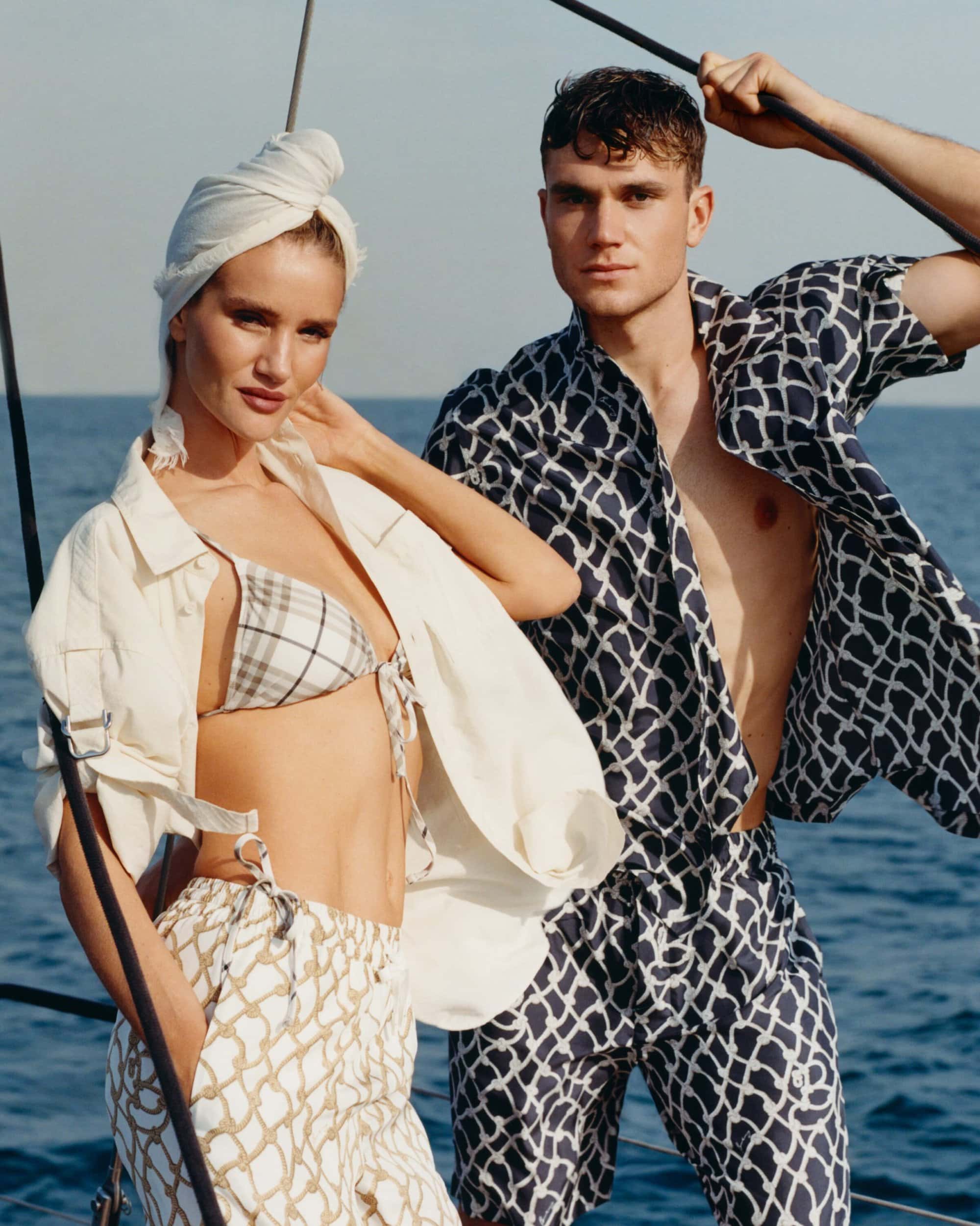 Rosie Huntington-Whiteley and Jack Draper on a boat wearing Burberry summer apparel against the open ocean.