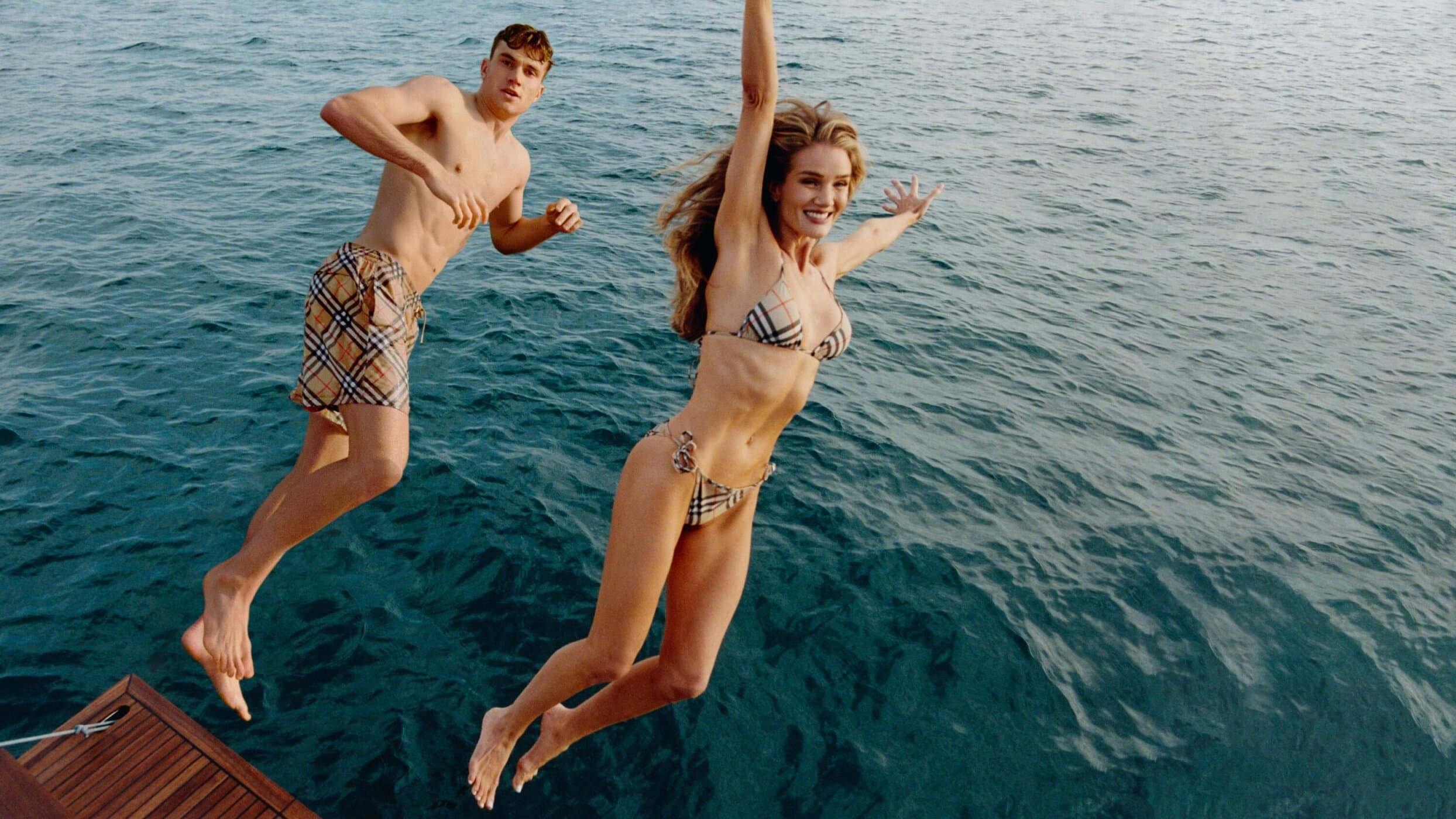 Jack Draper and Rosie Huntington-Whiteley jumping into the ocean for the Burberry Summer 2025 campaign