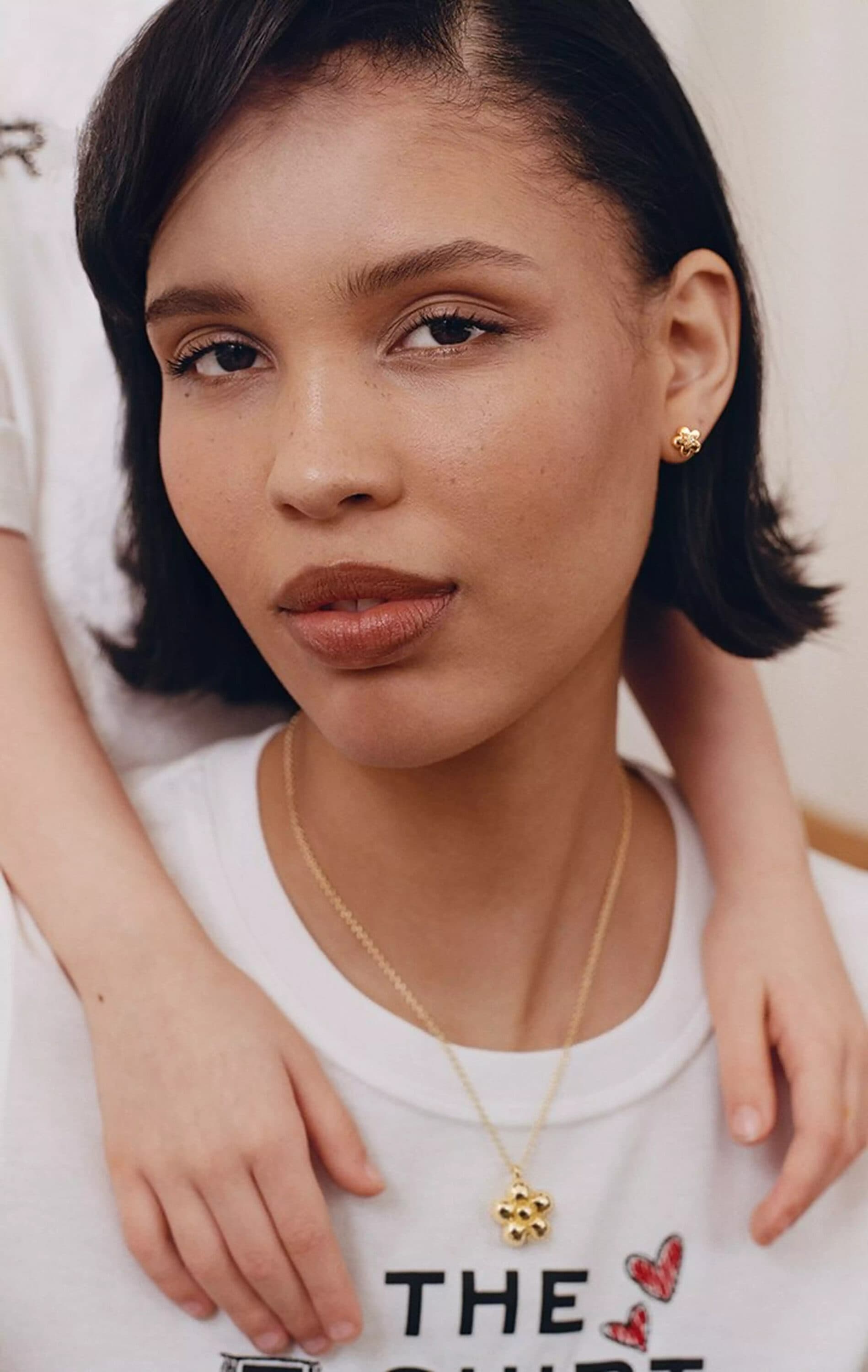 Close-up portrait of Nara Smith wearing a white t-shirt and gold necklace for Marc Jacobs Mother's Day campaign