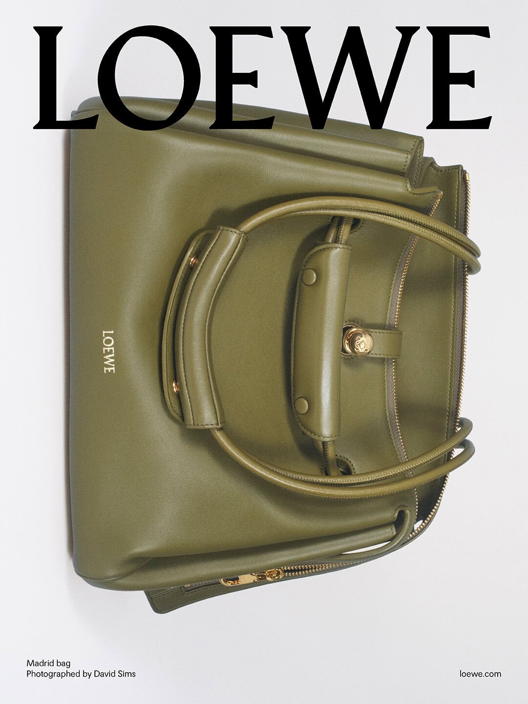 Olive green leather Loewe Madrid bag displayed against a plain white seamless studio background.