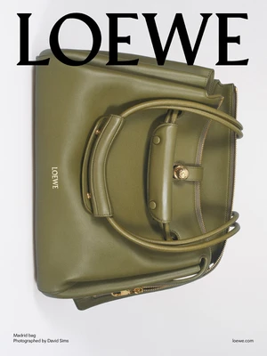 Olive green leather Loewe Madrid bag displayed against a plain white seamless studio background.