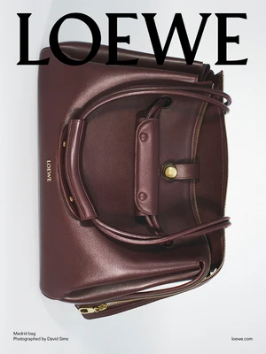 Burgundy leather Loewe Madrid bag against a plain white background with bold black typography overhead.