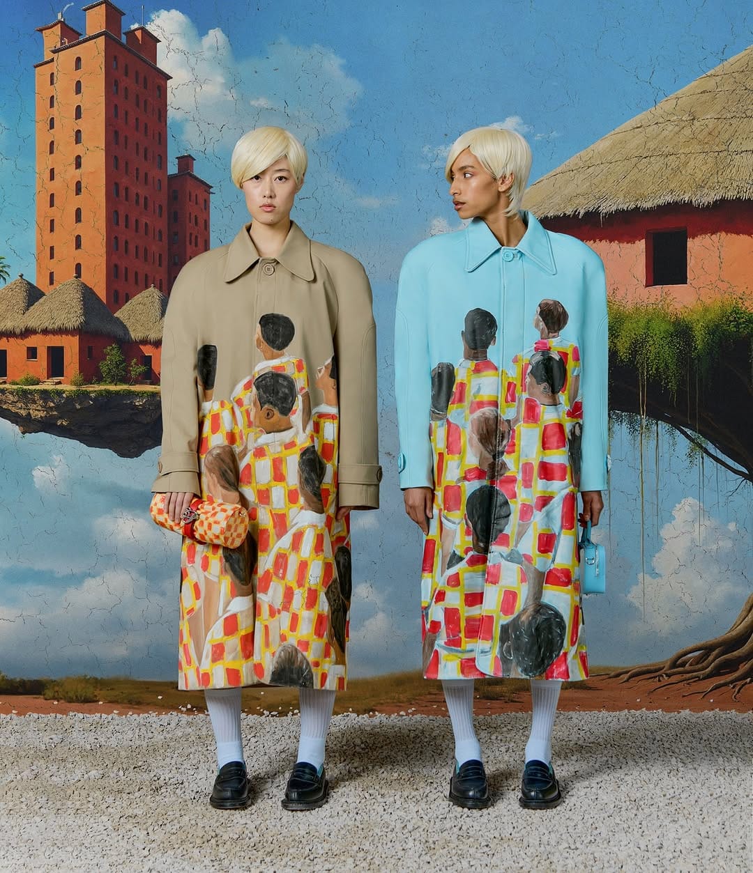 Two models with blonde hair wearing printed coats standing against a surreal painted landscape backdrop for 3.PARADIS Spring 2025 ad campaign