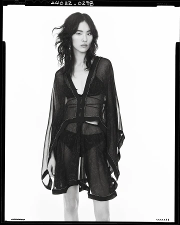 Model in sheer black overlay top and briefs against a seamless white background, photographed by Steven Meisel for Zara