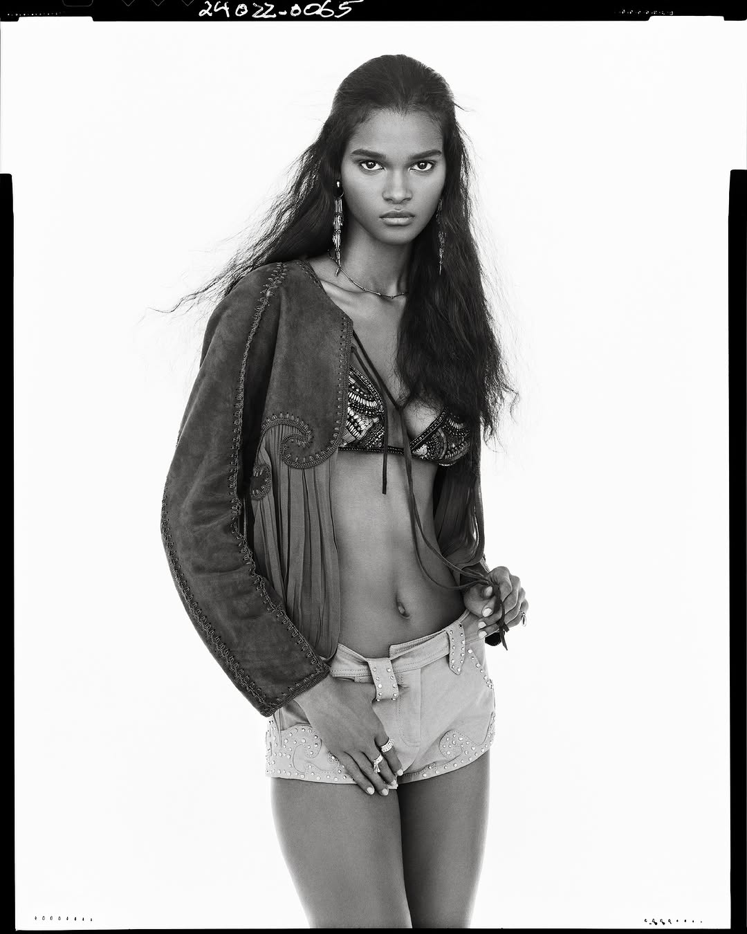 Model wearing embroidered jacket and shorts against a bright white background for Zara Studio Spring 2025 campaign