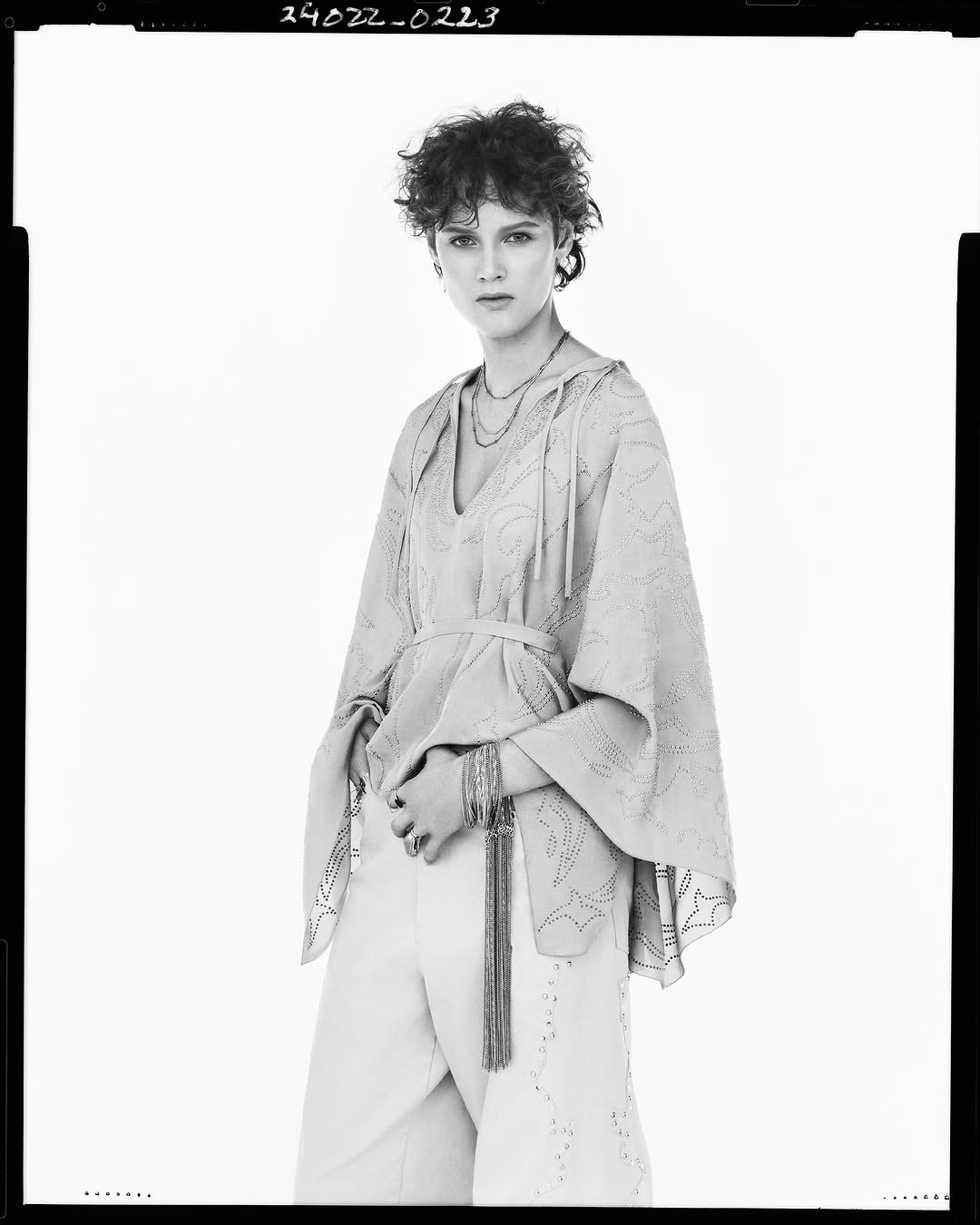 Model in patterned tunic and trousers against a white background for Zara Studio Spring 2025 campaign