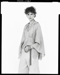 Model in patterned tunic and trousers against a white background for Zara Studio Spring 2025 campaign