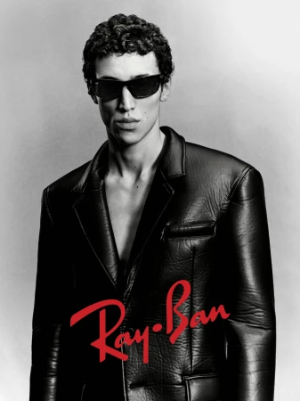 Man wearing sunglasses and a black leather jacket against a grey background with the red Ray-Ban logo