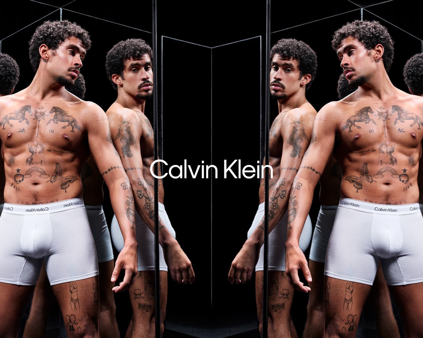 Bad Bunny shirtless wearing white Calvin Klein underwear in a reflective mirror installation for the Spring 2025 campaign