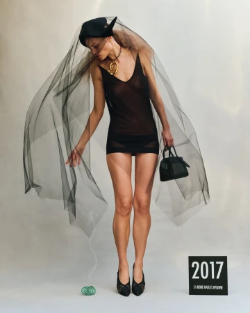 Model in a sheer black slip dress with veil and handbag for the Jacquemus Spring 2025 ad campaign.