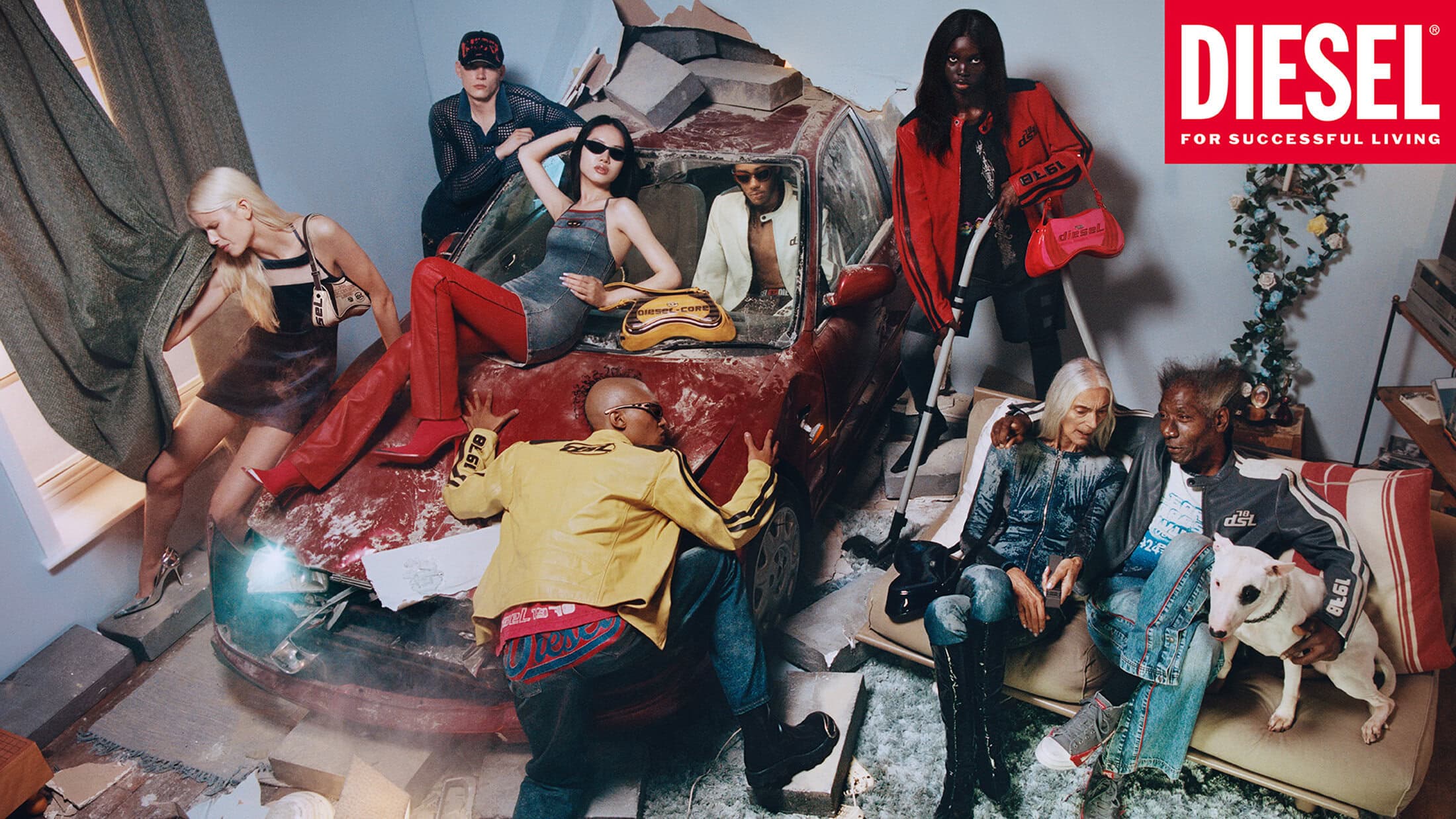 Group of models posed around a wrecked red car and a sofa indoors, featuring Diesel fashion campaign styling.