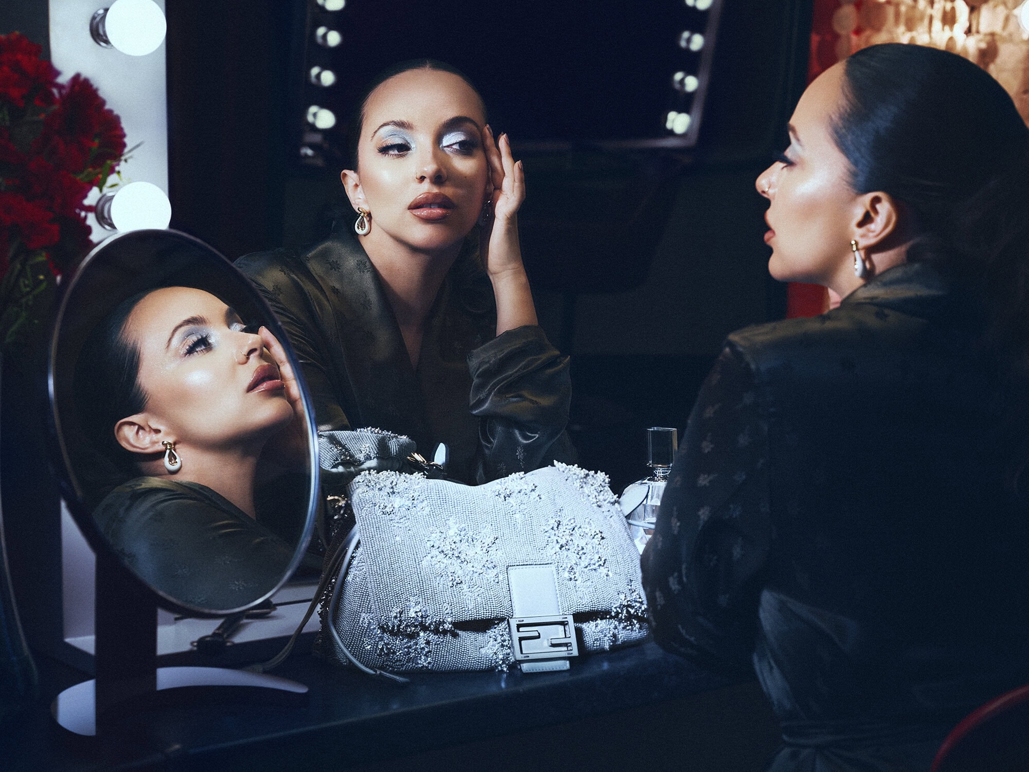 Talent Jade Thirlwall posing with a sparkling Fendi Baguette bag surrounded by vanity mirrors in an ad campaign