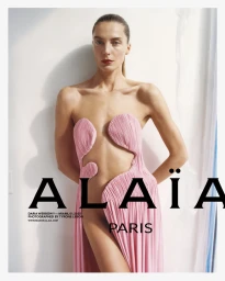 Model Daria Werbowy in a structured pink dress for Alaïa Spring 2025 campaign, photographed by Tyrone Lebon against a white background.