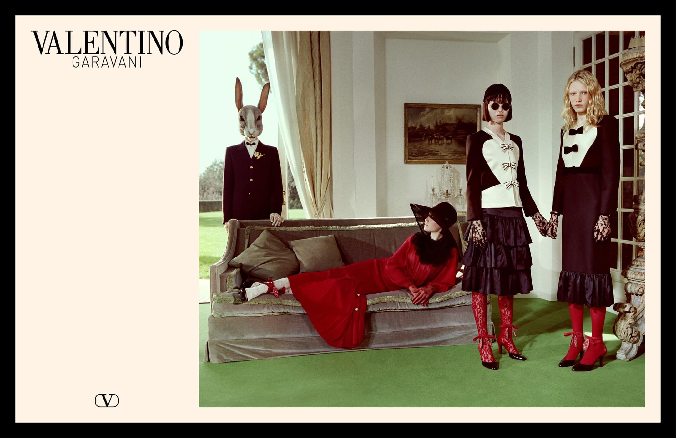 Valentino Spring 2025 campaign image featuring models in a room with a sofa and a figure wearing a rabbit mask.