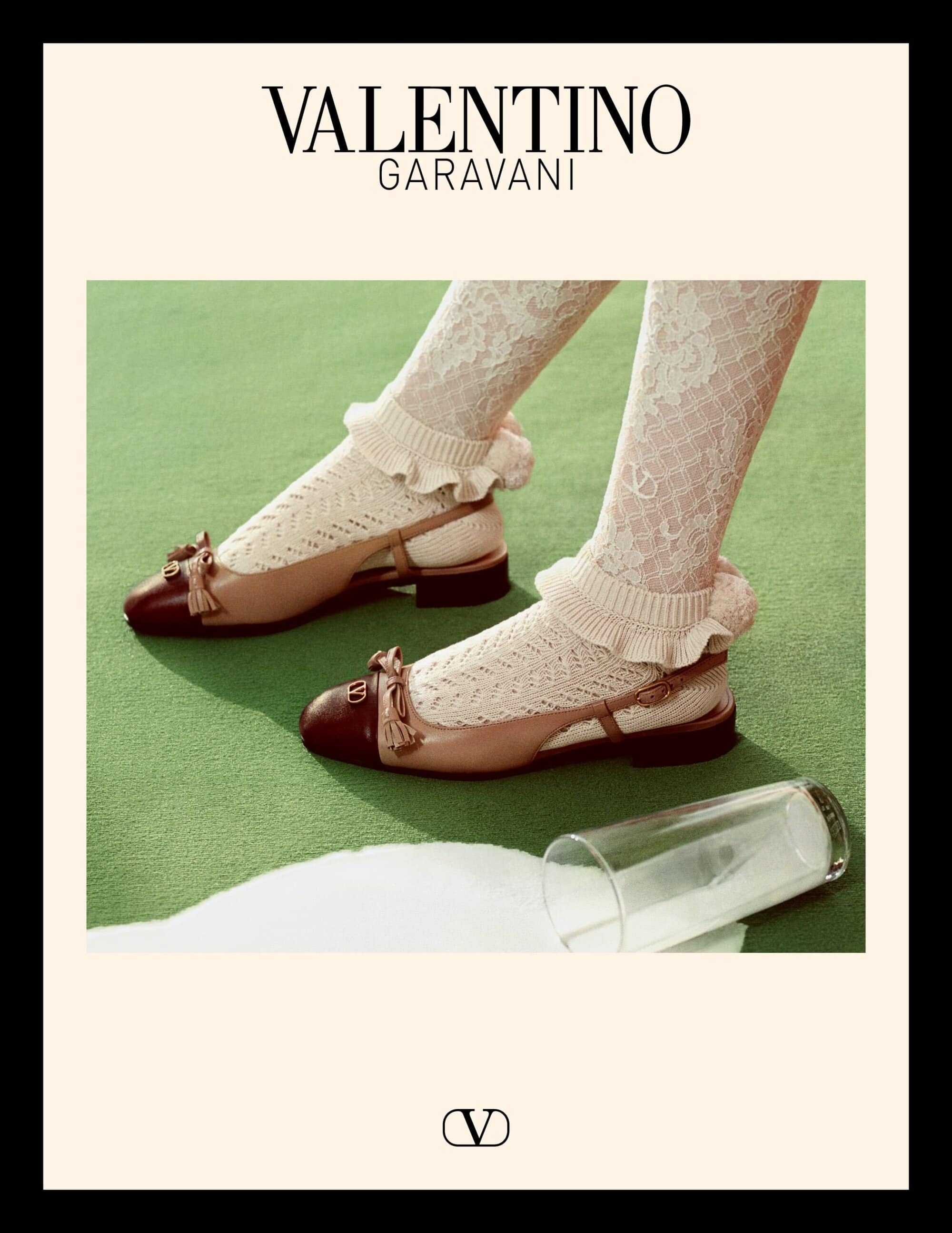 Valentino Garavani footwear ad featuring slingback flats and lace socks on a green carpet