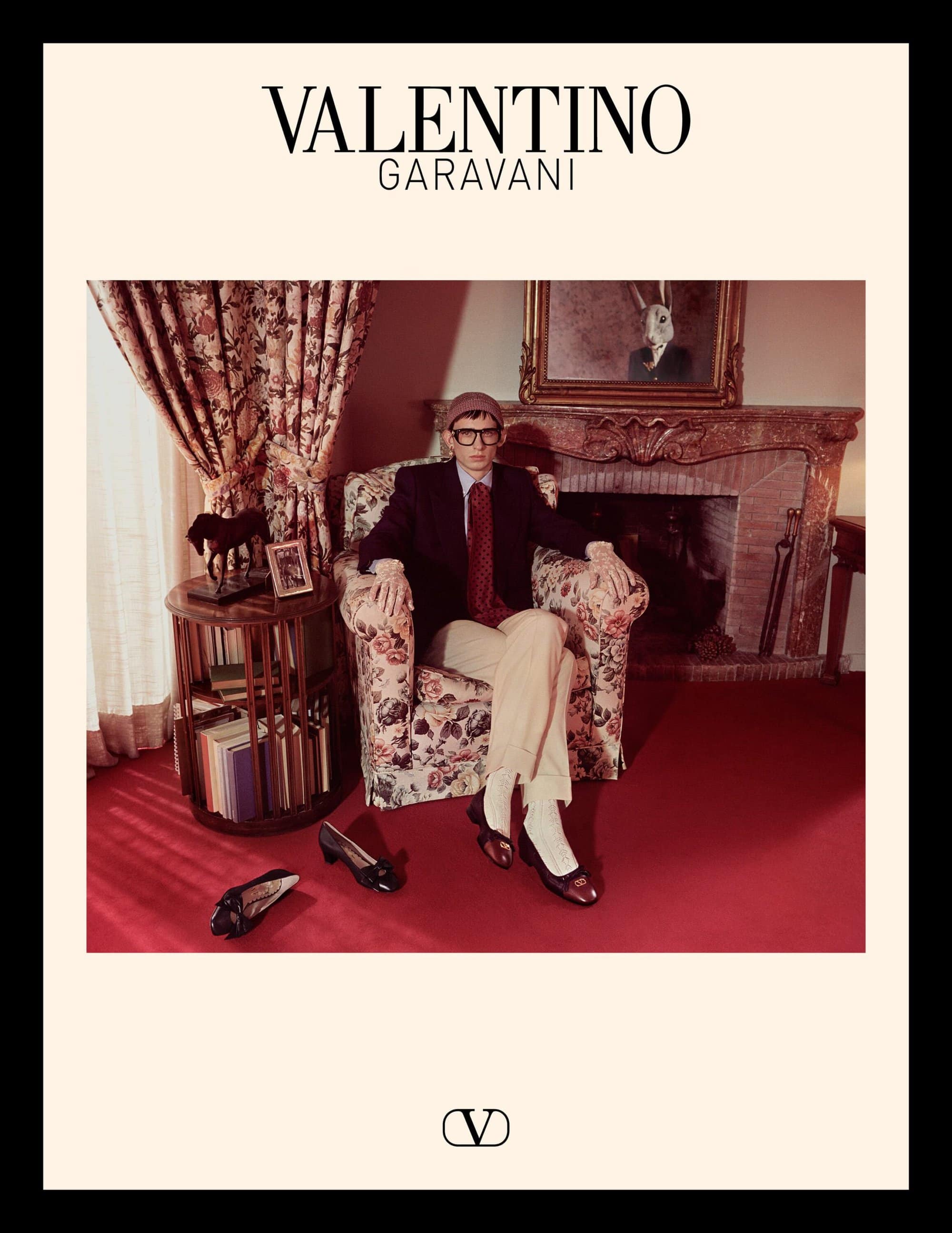 Model seated in an armchair inside a living room setting for Valentino Spring 2025 campaign