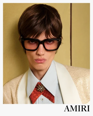 Model wearing dark framed sunglasses and embellished necktie in Amiri Spring 2025 ad campaign photographed by Drew Vickers