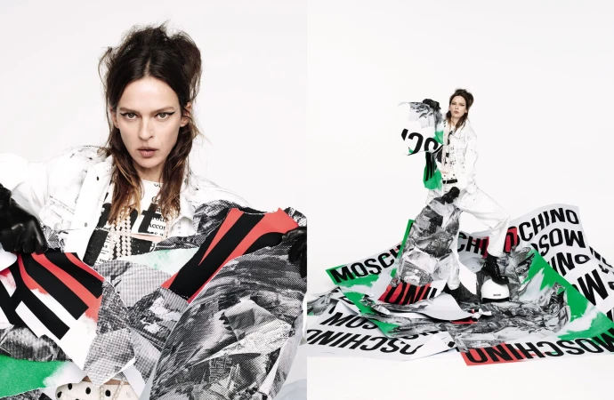 Model posing with torn graphic posters wearing white jacket against white background for Moschino