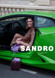 Model sitting in a bright green sports car knitting with purple yarn for Sandro Spring 2025 campaign