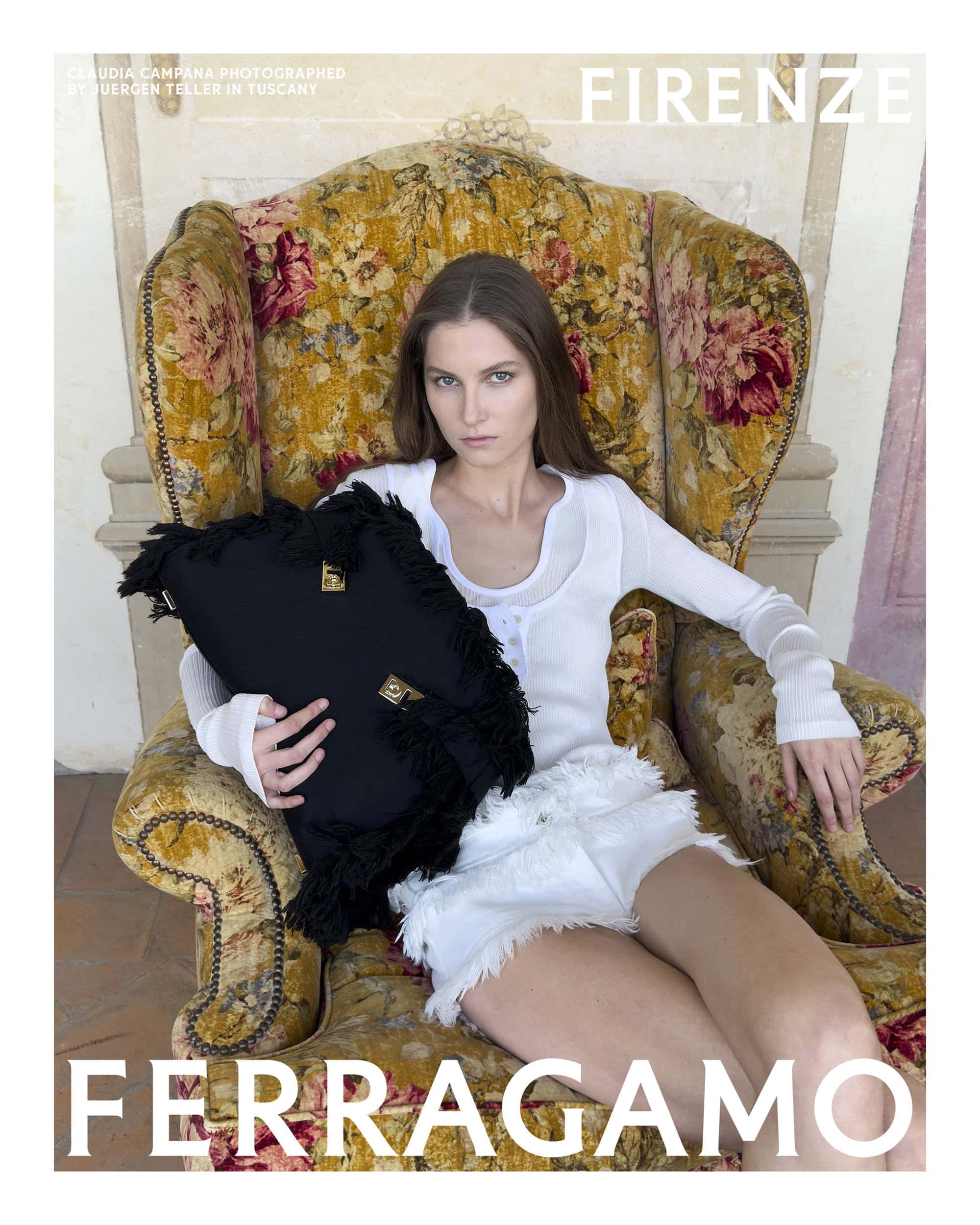 Claudia Campana seated in a floral armchair holding a black fringed handbag for Ferragamo Spring 2025 campaign