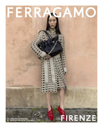 Liu Wen wearing a cut-out patterned coat and red heels holding a black handbag against a pink wall for Ferragamo.