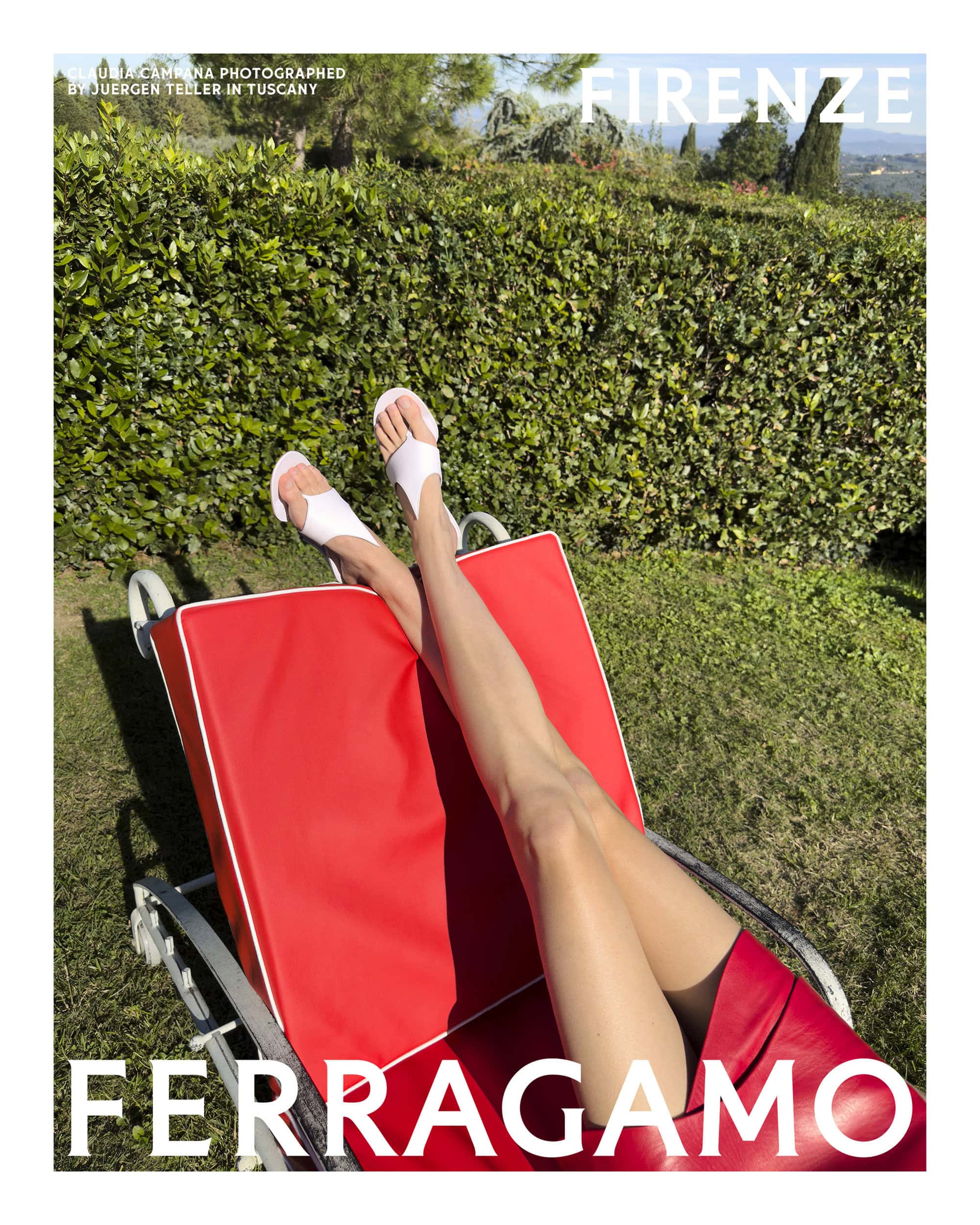 Model relaxing on a red sun lounger outdoors wearing white sandals and a red skirt for Ferragamo Spring 2025 ad campaign.