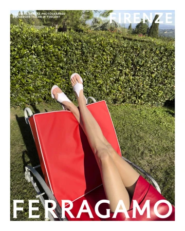 Model relaxing on a red sun lounger outdoors wearing white sandals and a red skirt for Ferragamo Spring 2025 ad campaign.