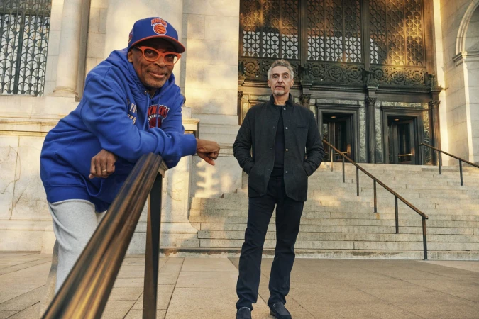 Spike Lee leaning on a railing and John Turturro standing on stone steps outside a New York City building for Nordstrom.