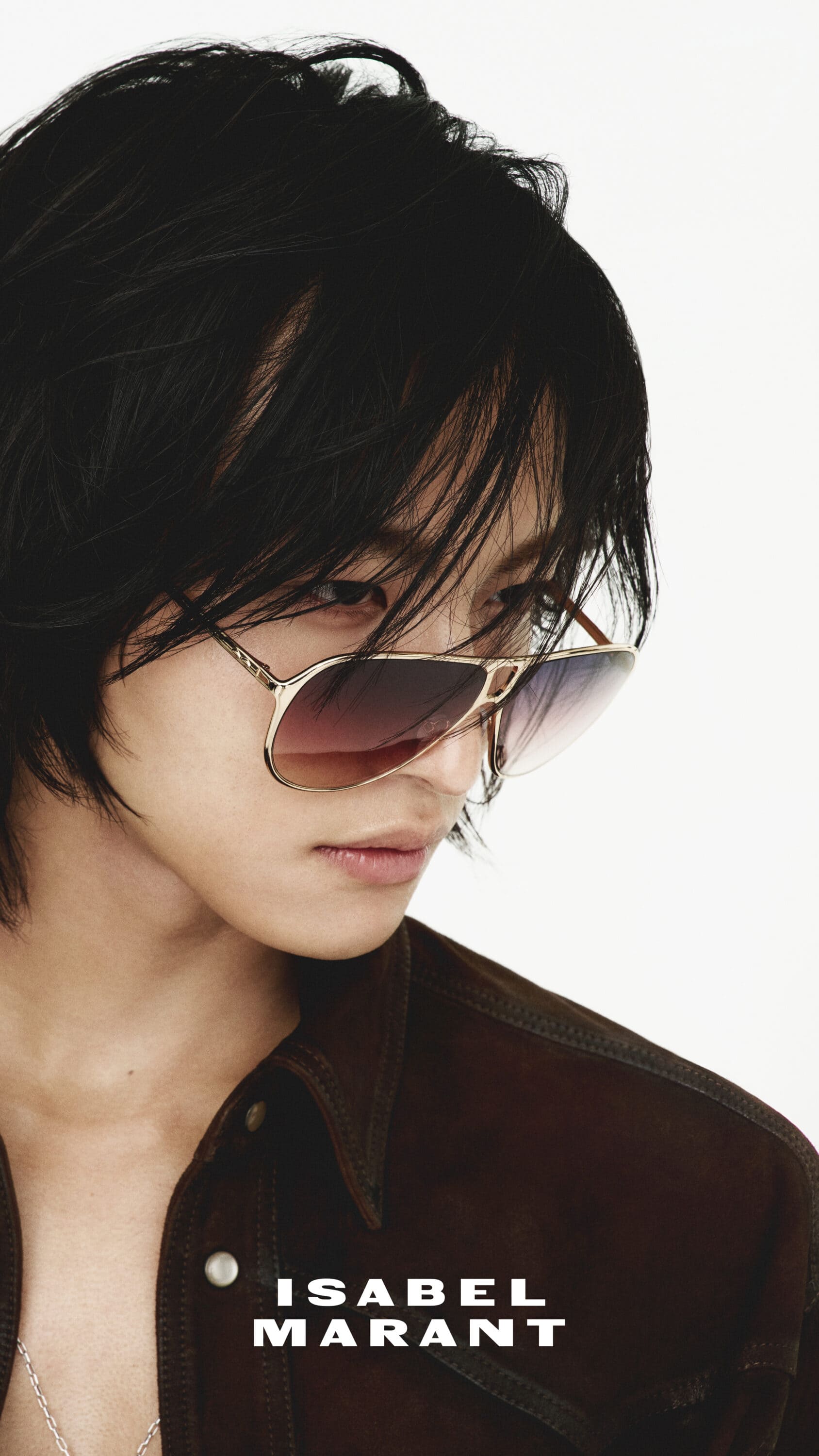 Close-up portrait of Seonghwa wearing tinted aviator sunglasses and a dark brown shirt against a plain white background for Isabel Marant.