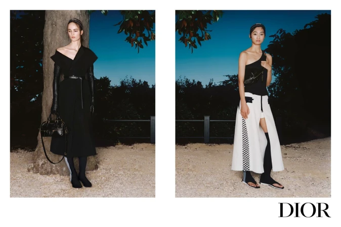 Two fashion models posing outdoors at dusk for Dior Spring 2025 ad campaign, wearing black and white designer clothing.