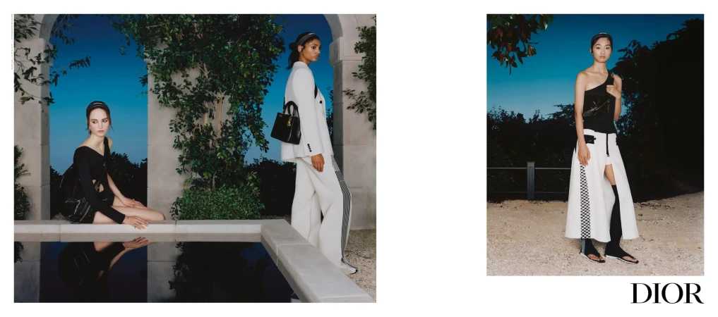 Models in Dior fashion campaign posing near an outdoor pool and gravel path at dusk