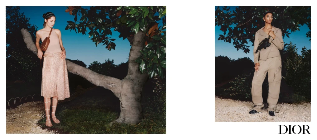 Two fashion models posing outdoors at dusk near leafy trees for the Dior Spring 2025 ad campaign, photographed by Sarah Jones.