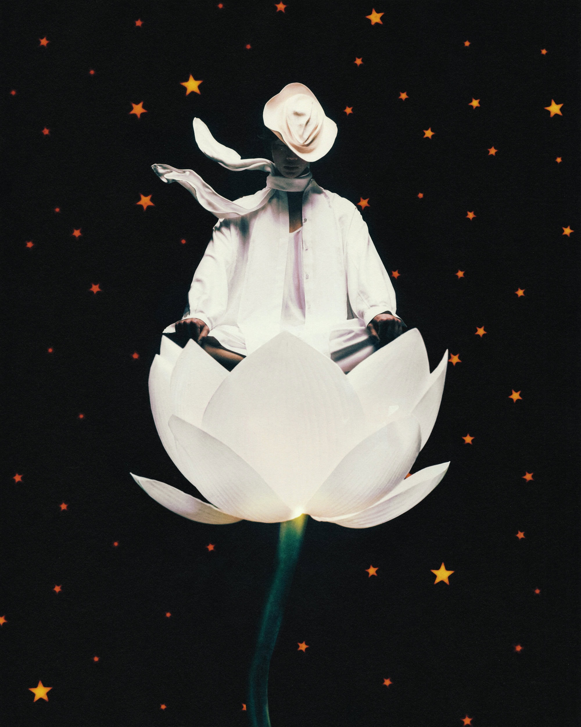 Model in white clothing meditating inside a large white lotus flower against a dark starry background
