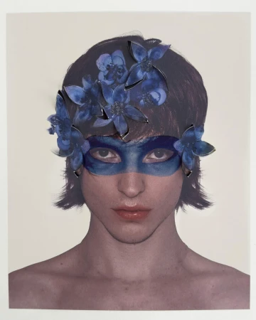 Portrait of a model wearing a blue floral mask and flower headpiece for Paul Andrew Spring 2025 campaign