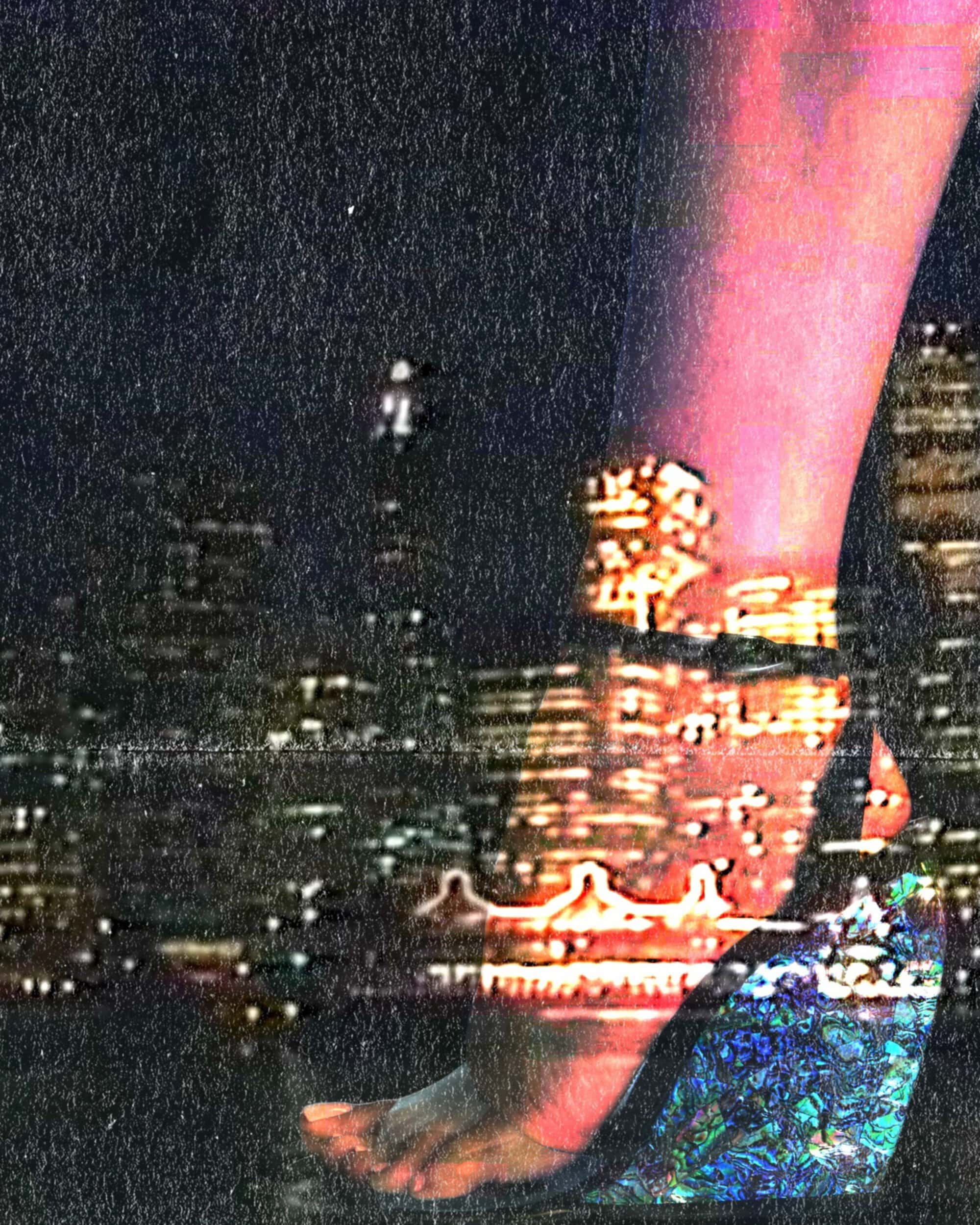 Close-up of a person's leg and foot wearing a heeled shoe against a nighttime cityscape background with grainy texture