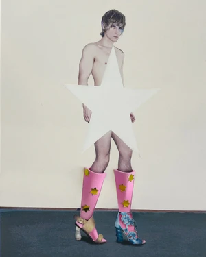 Collage artwork featuring a man partially obscured by a large white star prop wearing pink boots and patterned sandals