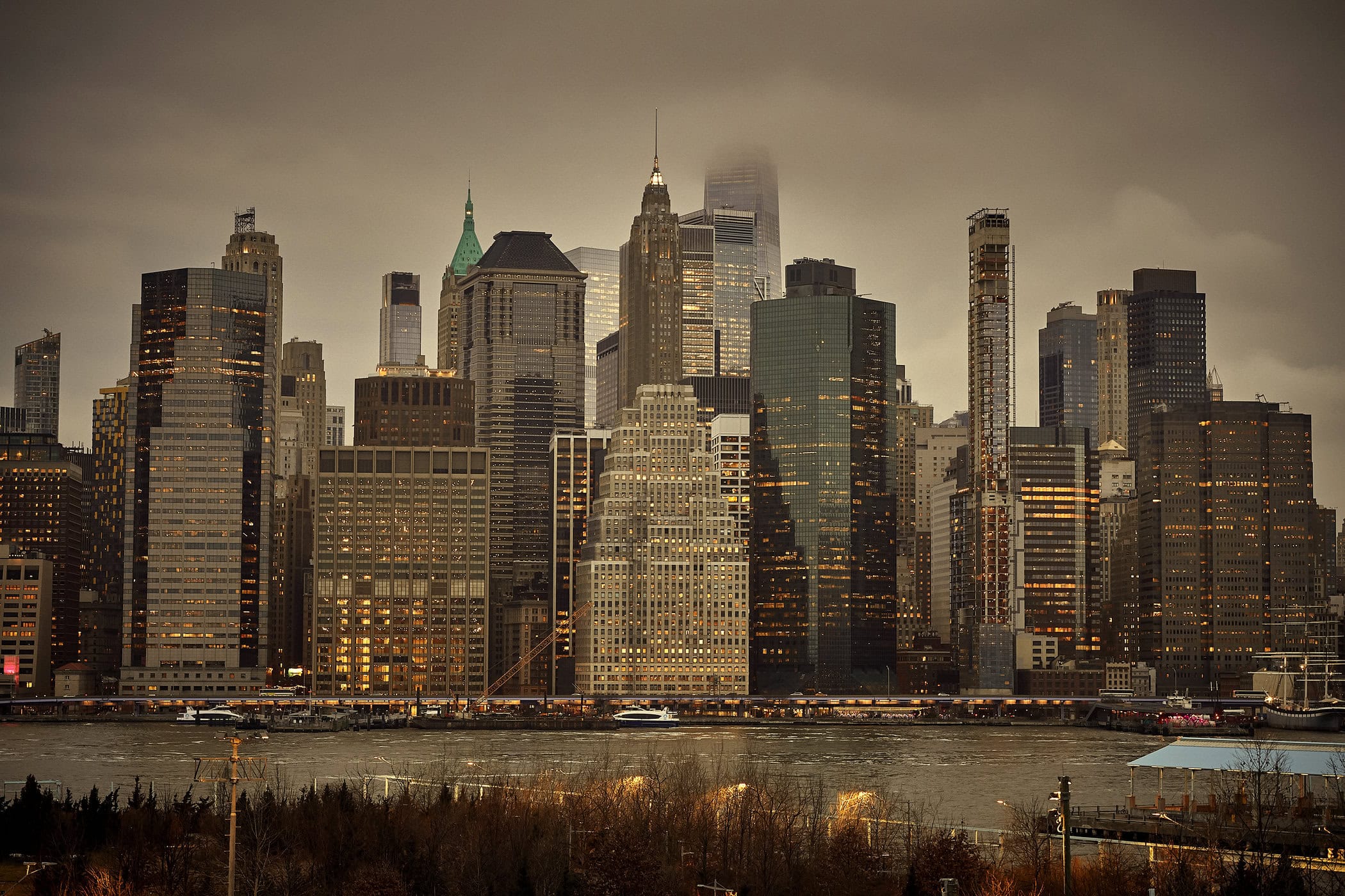New York City skyline viewed across a river under an overcast, moody sky for Dior Homme Parfum ad campaign.