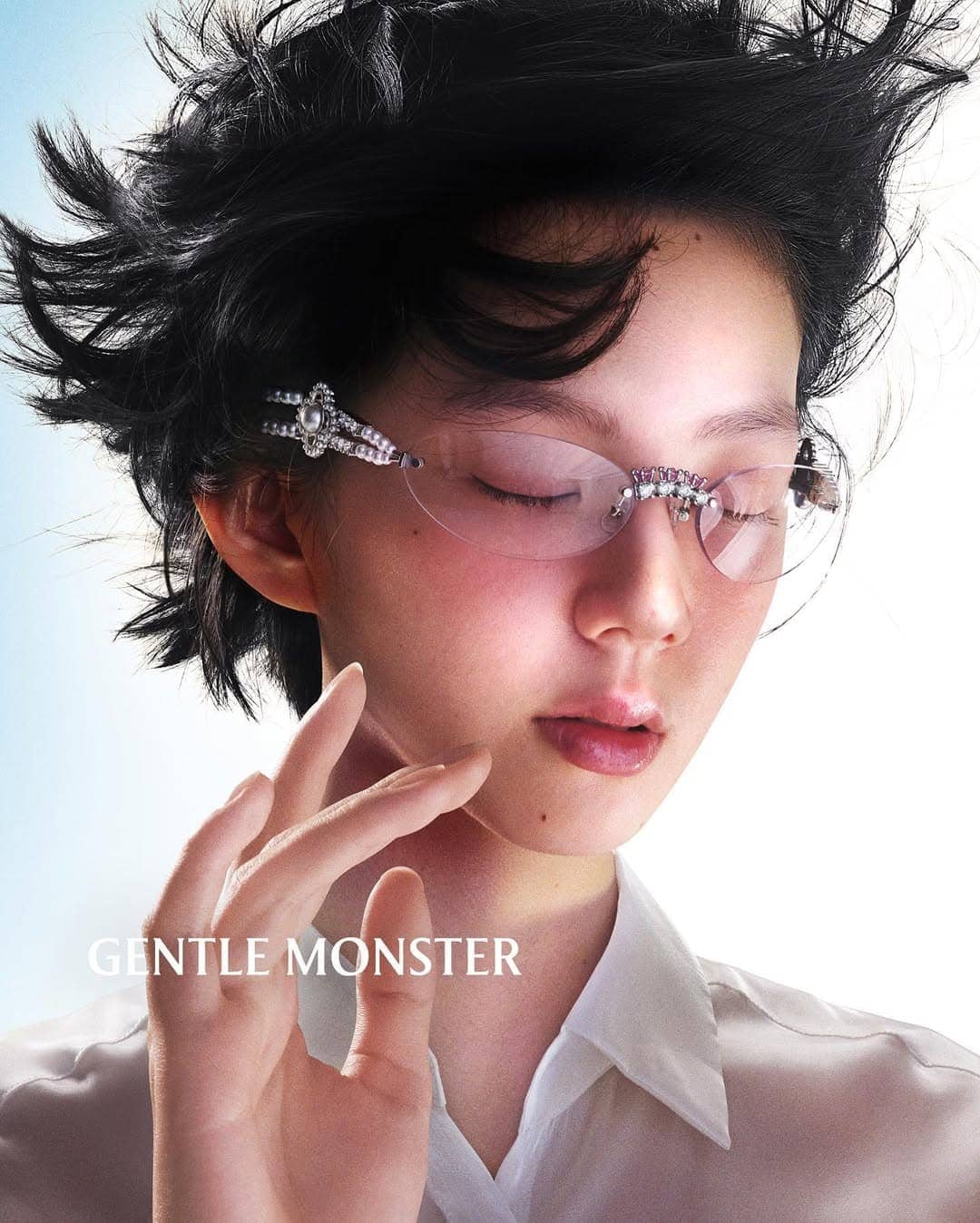 Model Sena Nakajima wearing jeweled rimless glasses and a white button shirt for Gentle Monster spring 2025 campaign.