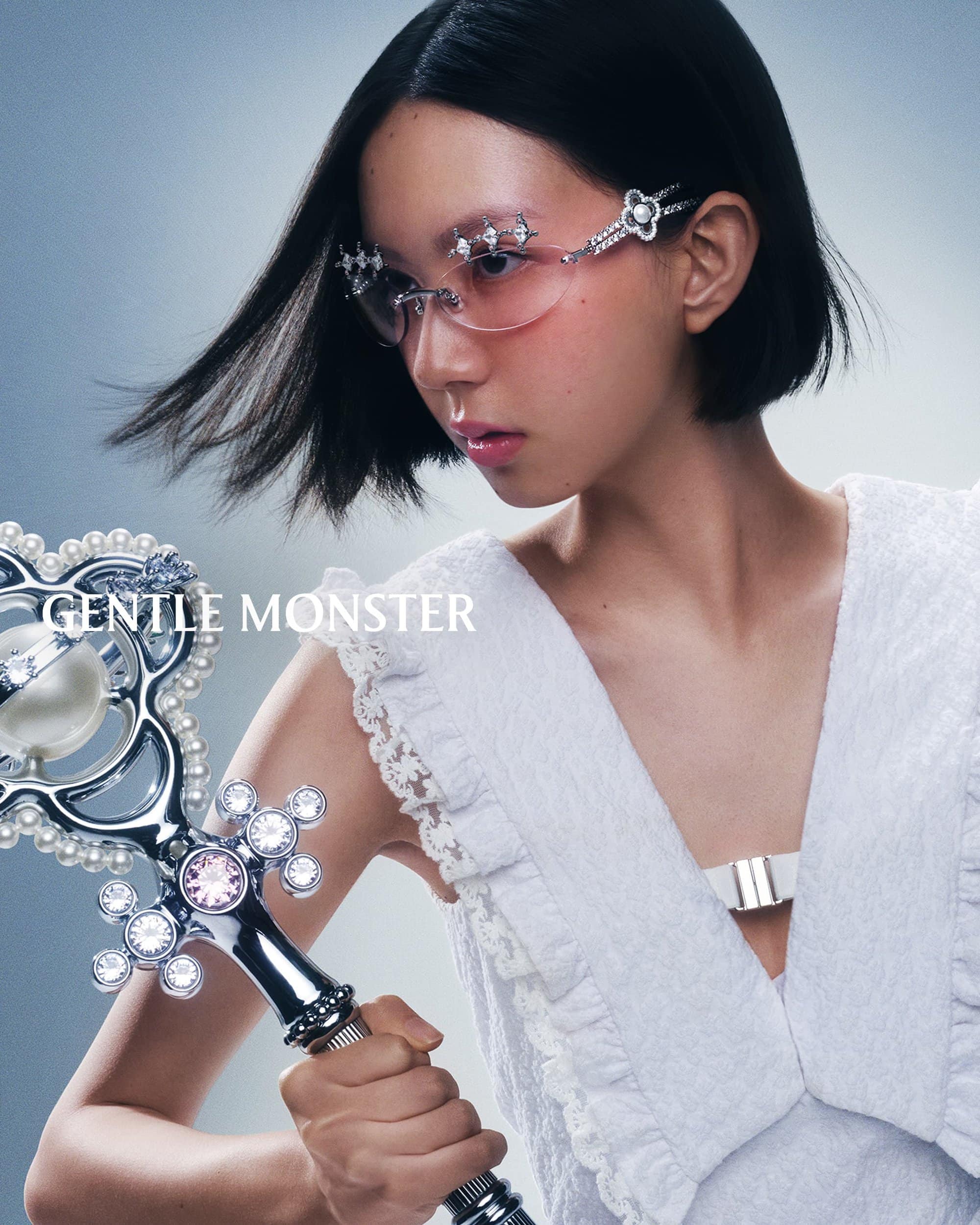 Model Sena Nakajima wearing jeweled rimless sunglasses and holding an ornate jeweled scepter for Gentle Monster Spring 2025 campaign.