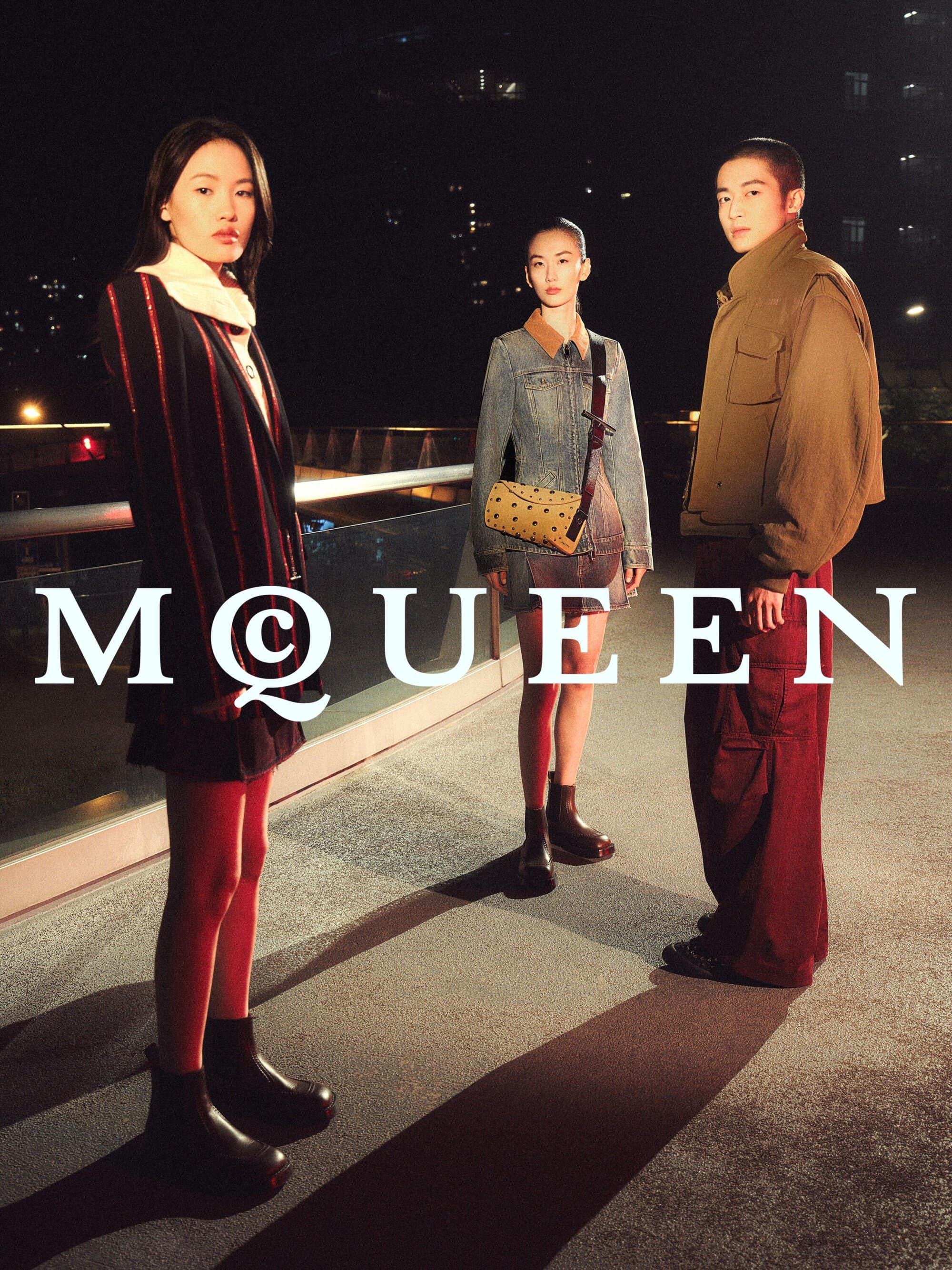 Three models posing outdoors on an urban rooftop at night for a McQueen Lunar New Year advertising campaign.