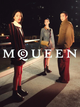 Three models posing outdoors on an urban rooftop at night for a McQueen Lunar New Year advertising campaign.