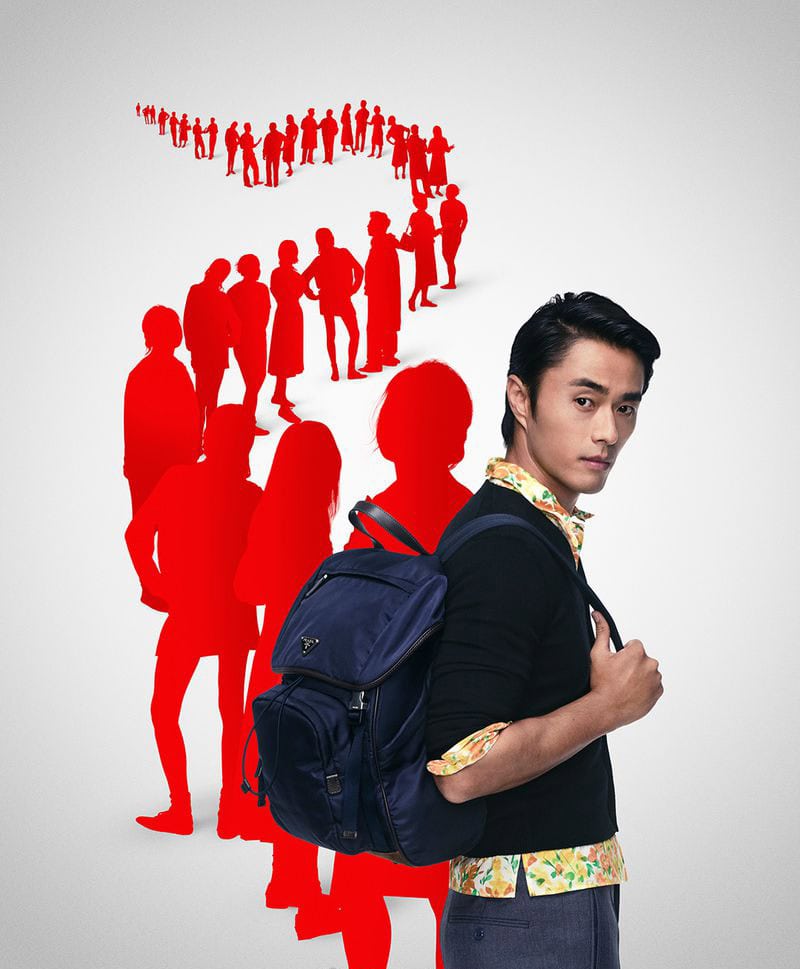 Man wearing a black sweater with a blue backpack against a white background featuring a red silhouette crowd