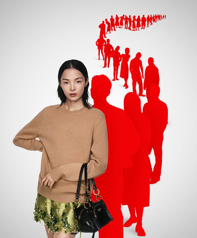 Model in camel sweater holding black handbag against a white background with a winding line of red silhouettes.