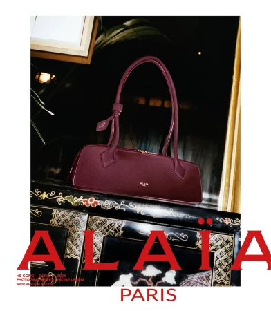 Burgundy leather handbag resting on an ornate black and gold cabinet for Alaïa Lunar New Year campaign