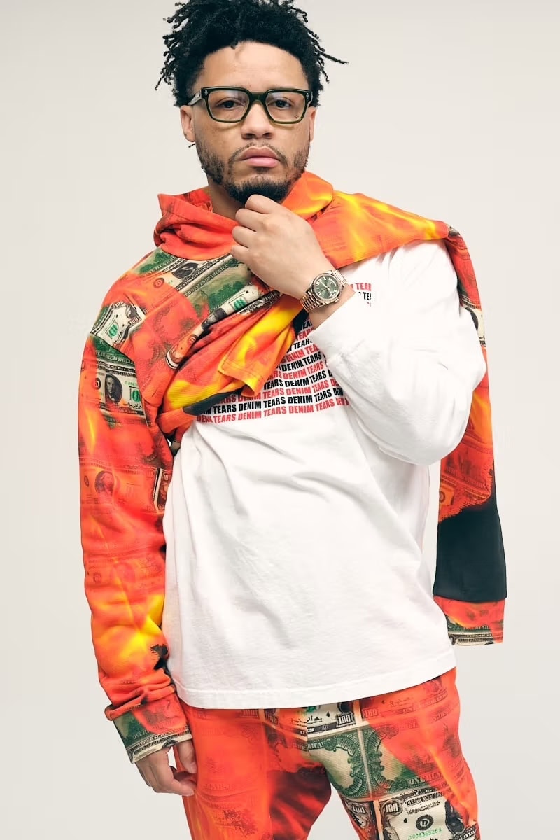 Veeze wearing a money-print tracksuit and white long-sleeve top for Denim Tears Winter 2024 campaign