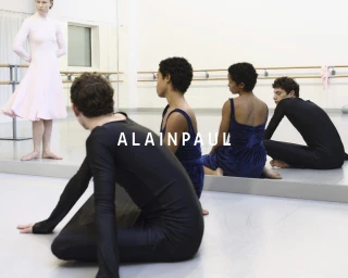 Dancers in black and pink dancewear inside a ballet studio with mirrors and ballet barres for Alainpaul Fall 2024 Ad Campaign